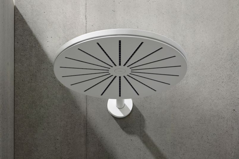 A wall-mounted VOLA 060 round-head shower in Matt White.