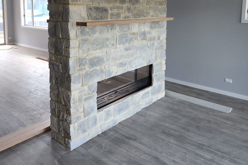 Dry Stack Collection in Granite, installed for a fireplace.